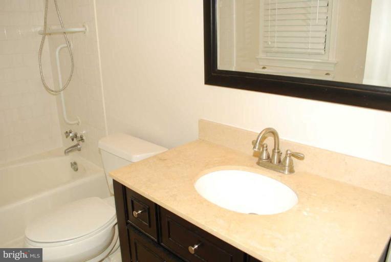 1904 Old Stage Road Alexandria, VA 22308 - Photo 19 of 21 a bathroom with a granite countertop sink and a mirror