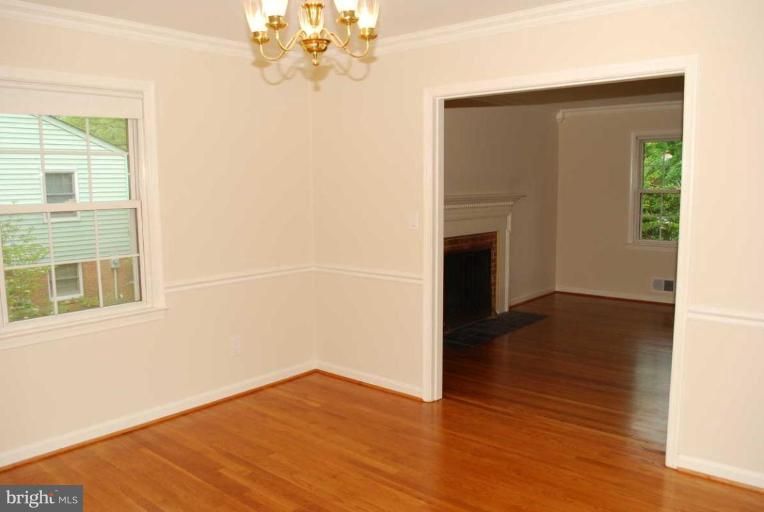 1904 Old Stage Road Alexandria, VA 22308 - Photo 5 of 21 a view of an empty room with wooden floor and a window