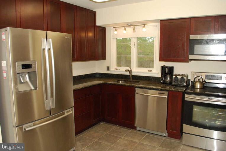 1904 Old Stage Road Alexandria, VA 22308 - Photo 6 of 21 a kitchen with stainless steel appliances granite countertop a refrigerator and a sink