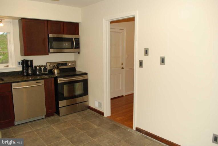1904 Old Stage Road Alexandria, VA 22308 - Photo 7 of 21 a kitchen with a sink and a stove top oven