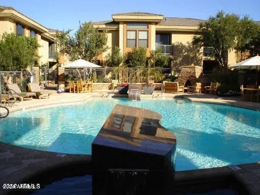 a view of a house with backyard porch and sitting area