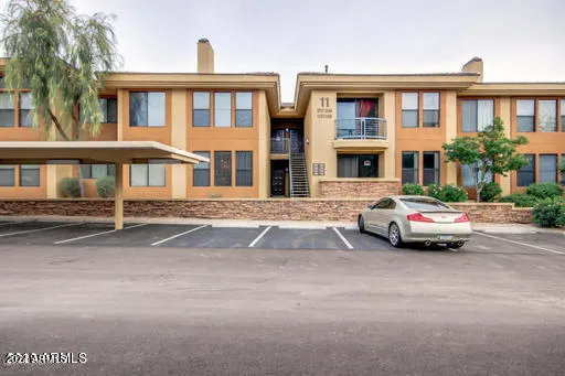 a car parked in front of a white house
