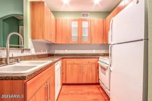 a bathroom with a granite countertop sink and a large mirror