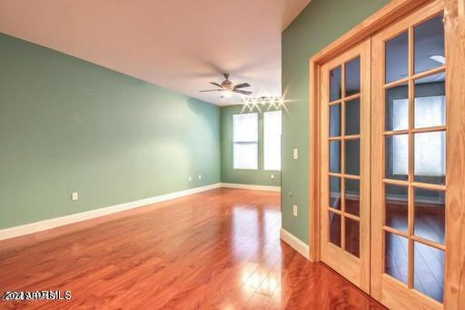 6900 East Princess Drive, Unit 2159 Phoenix, AZ 85054 - Photo 6 of 17 a view of an empty room with a window and wooden floor
