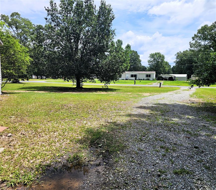 12910 Springhaven Drive Keithville, LA 71047 - Photo 30 of 33 Gravel driveway leading up the left side of the home