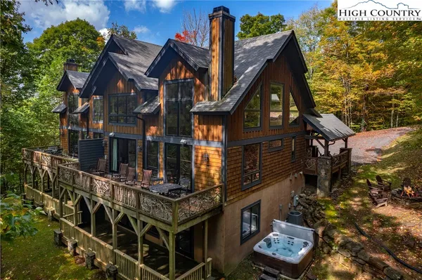 a view of a house with a small yard and large tree