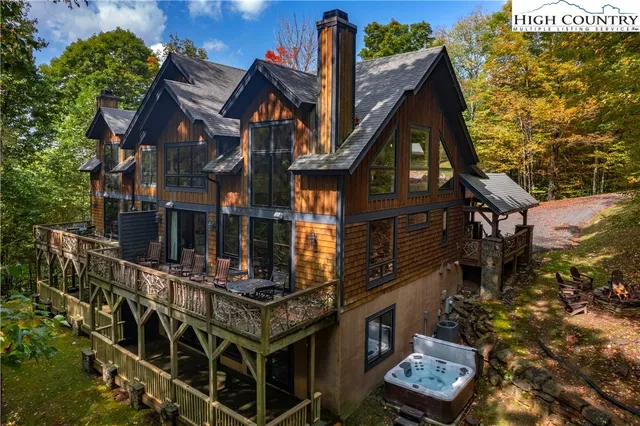 a view of a house with a small yard and large tree