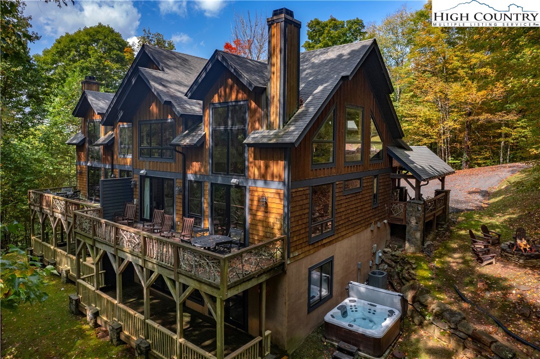 a view of a house with a small yard and large tree