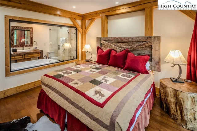 a bed sitting in a bedroom next to a window