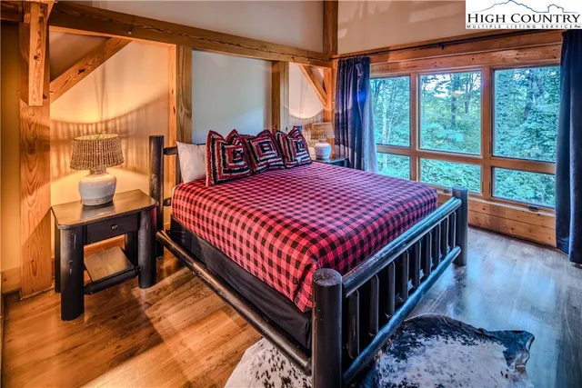 a bedroom with a bed a table and chair