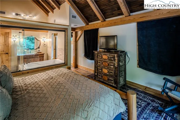 a bedroom with furniture and flat screen tv