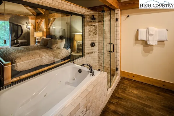 a spacious bathroom with a bathtub and shower