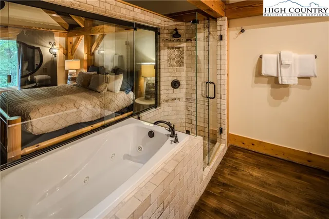 a spacious bathroom with a bathtub and shower