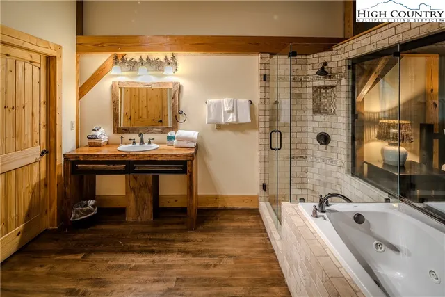 a bathroom with a sink a large mirror and a bathtub