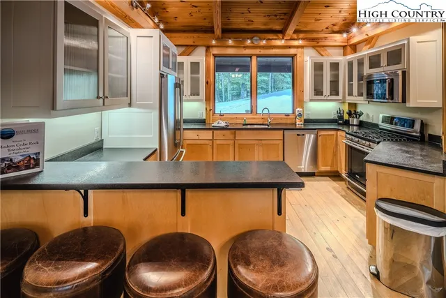a kitchen with a table chairs stove and sink