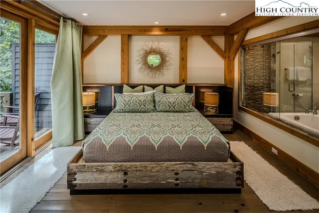 a bedroom with a bed and large window