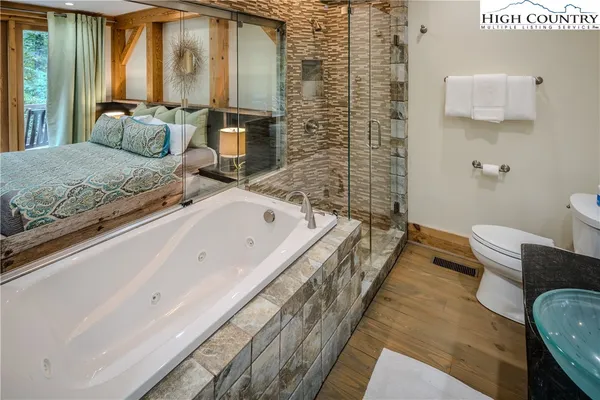 a bathroom with a granite countertop sink and a large mirror