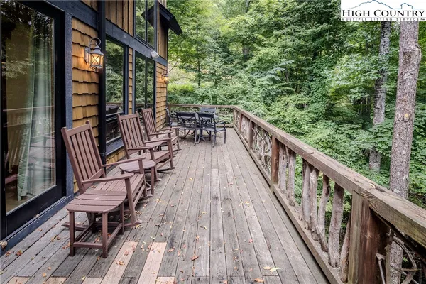a view of balcony with wooden floor and outdoor seating