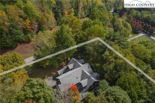 an aerial view of house with yard swimming pool and outdoor seating