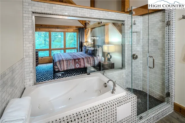 a bathroom with a bathtub and a shower