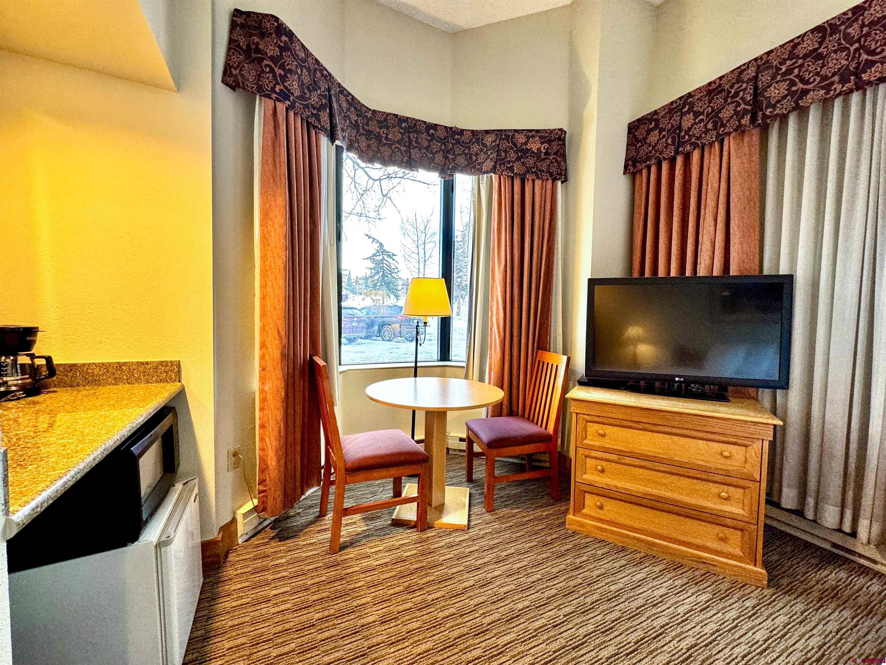 6 Emmons Road, Unit 181 Crested Butte, CO 81225 - Photo 3 of 25 a living room with furniture and a flat screen tv
