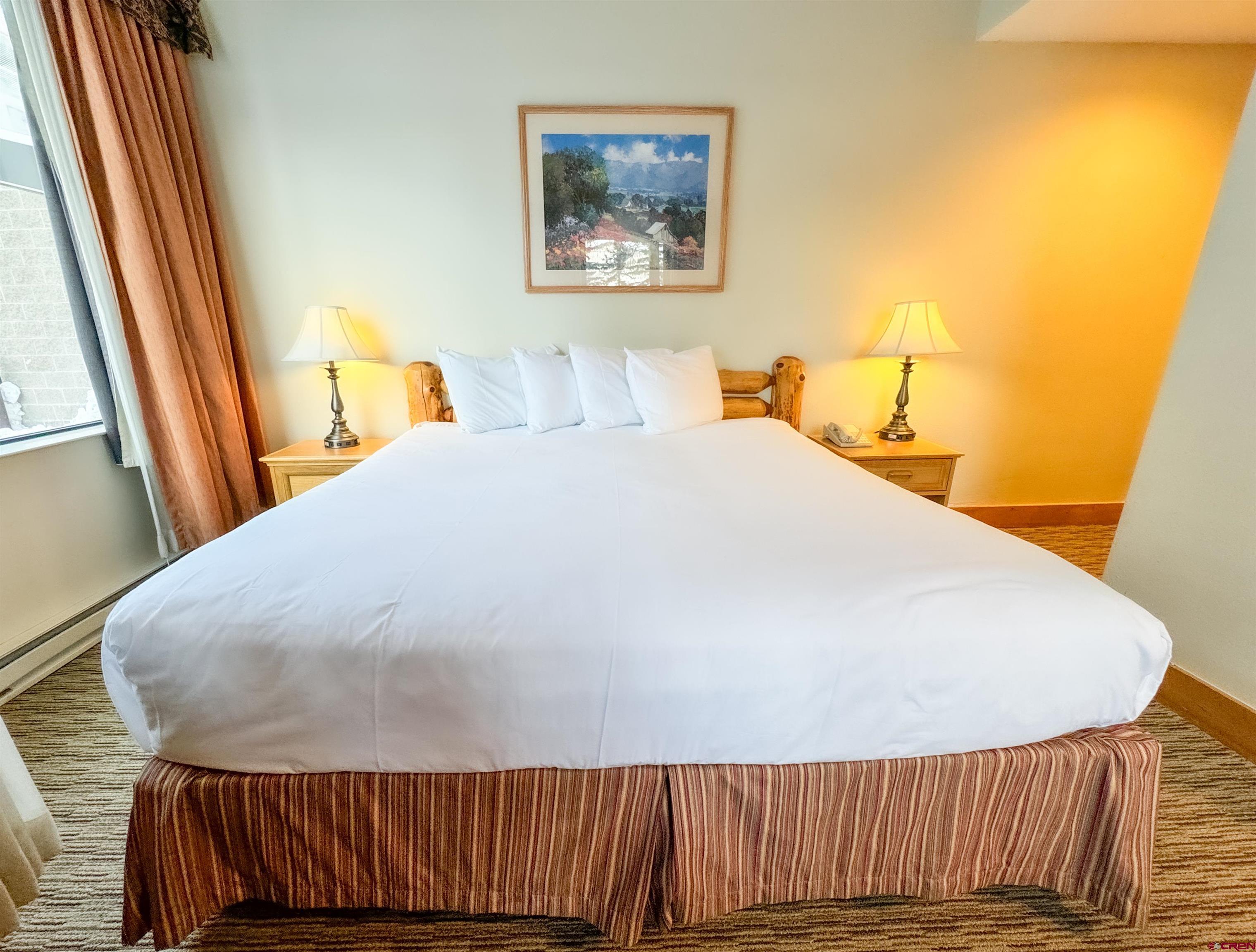 6 Emmons Road, Unit 181 Crested Butte, CO 81225 - Photo 5 of 25 a bedroom with a bed and a painting on the wall