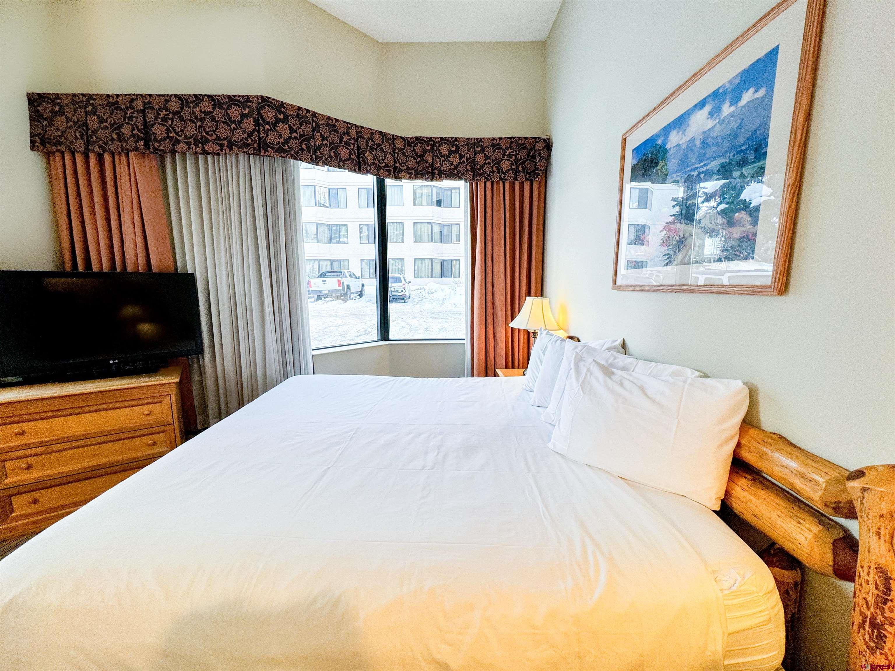6 Emmons Road, Unit 181 Crested Butte, CO 81225 - Photo 6 of 25 a bedroom with a bed and a view of balcony