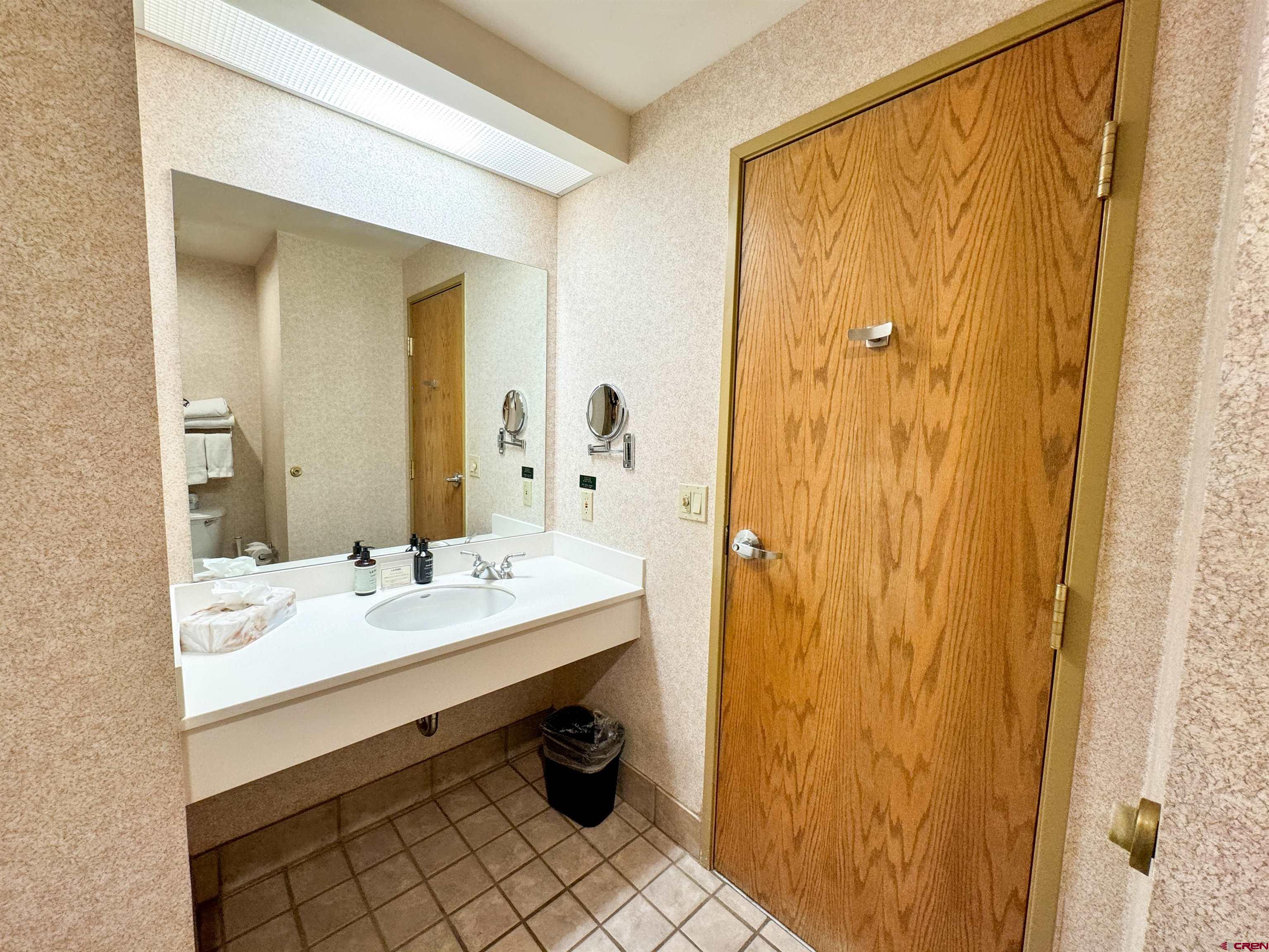 6 Emmons Road, Unit 181 Crested Butte, CO 81225 - Photo 10 of 25 a bathroom with a sink a mirror and a shower