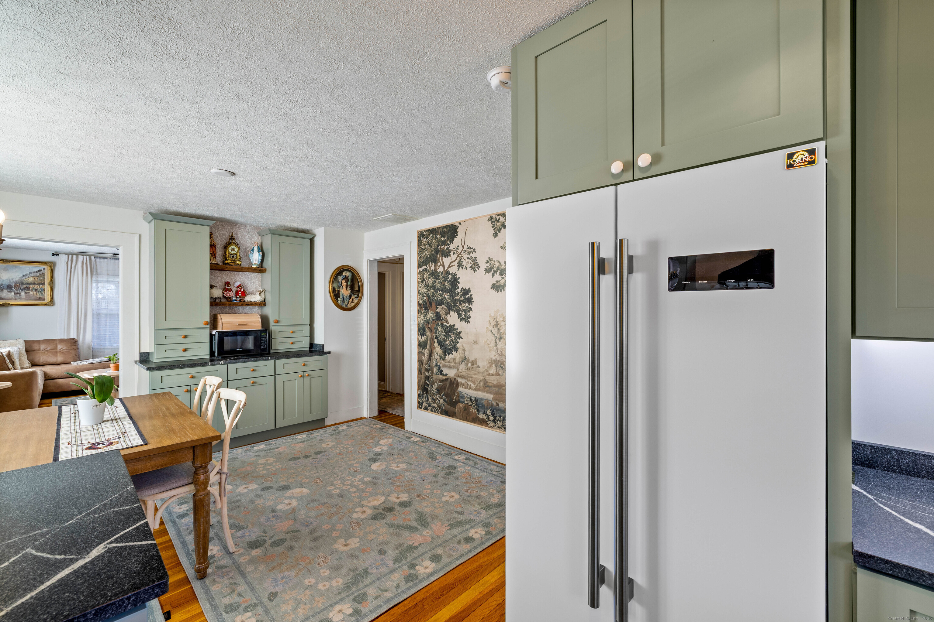 552 Laurel Hill Road Norwich, CT 06360 - Photo 17 of 40 a living room with furniture a flat screen tv and a refrigerator