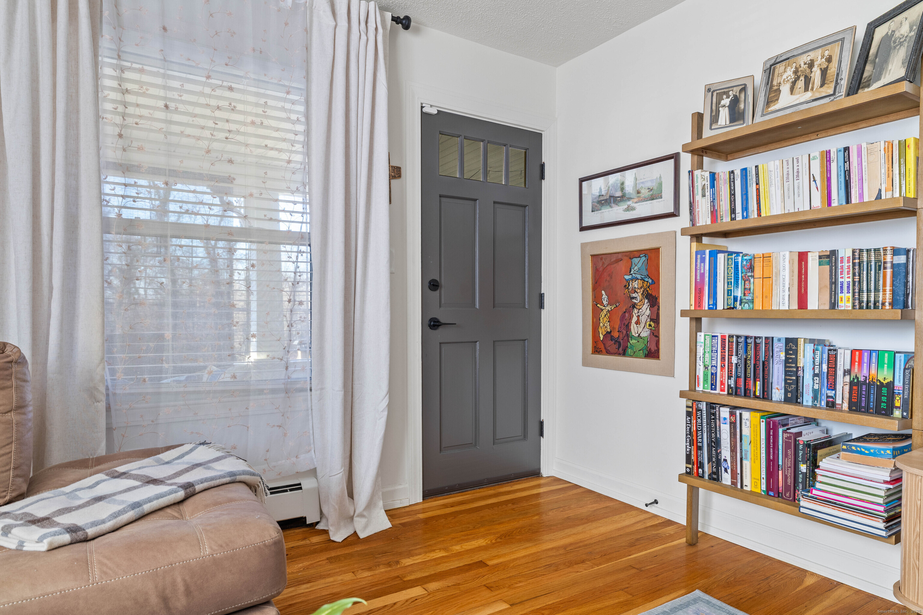 552 Laurel Hill Road Norwich, CT 06360 - Photo 19 of 40 a bedroom with a bed and a book shelf