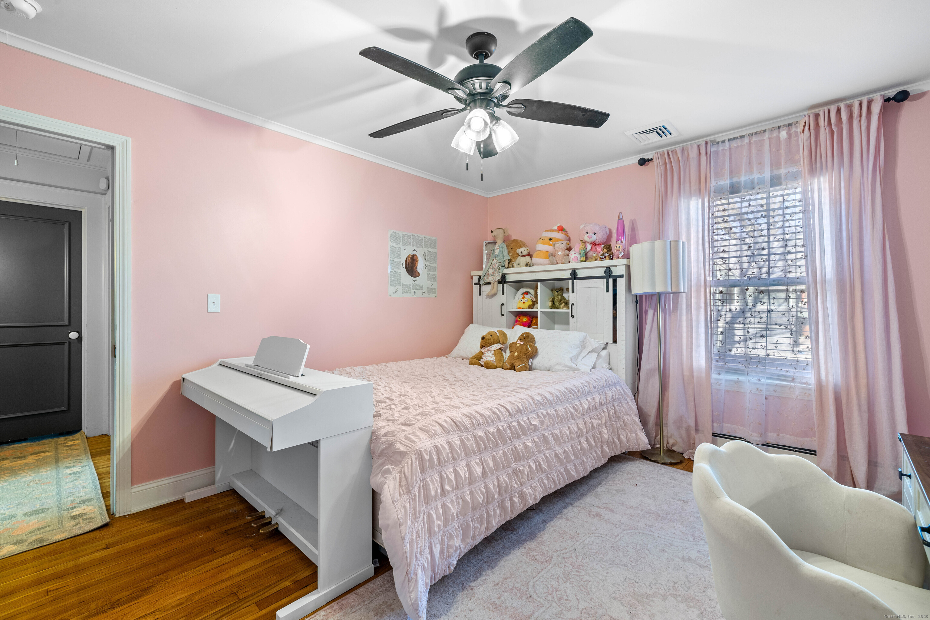 552 Laurel Hill Road Norwich, CT 06360 - Photo 22 of 40 a bedroom with a bed and a chandelier