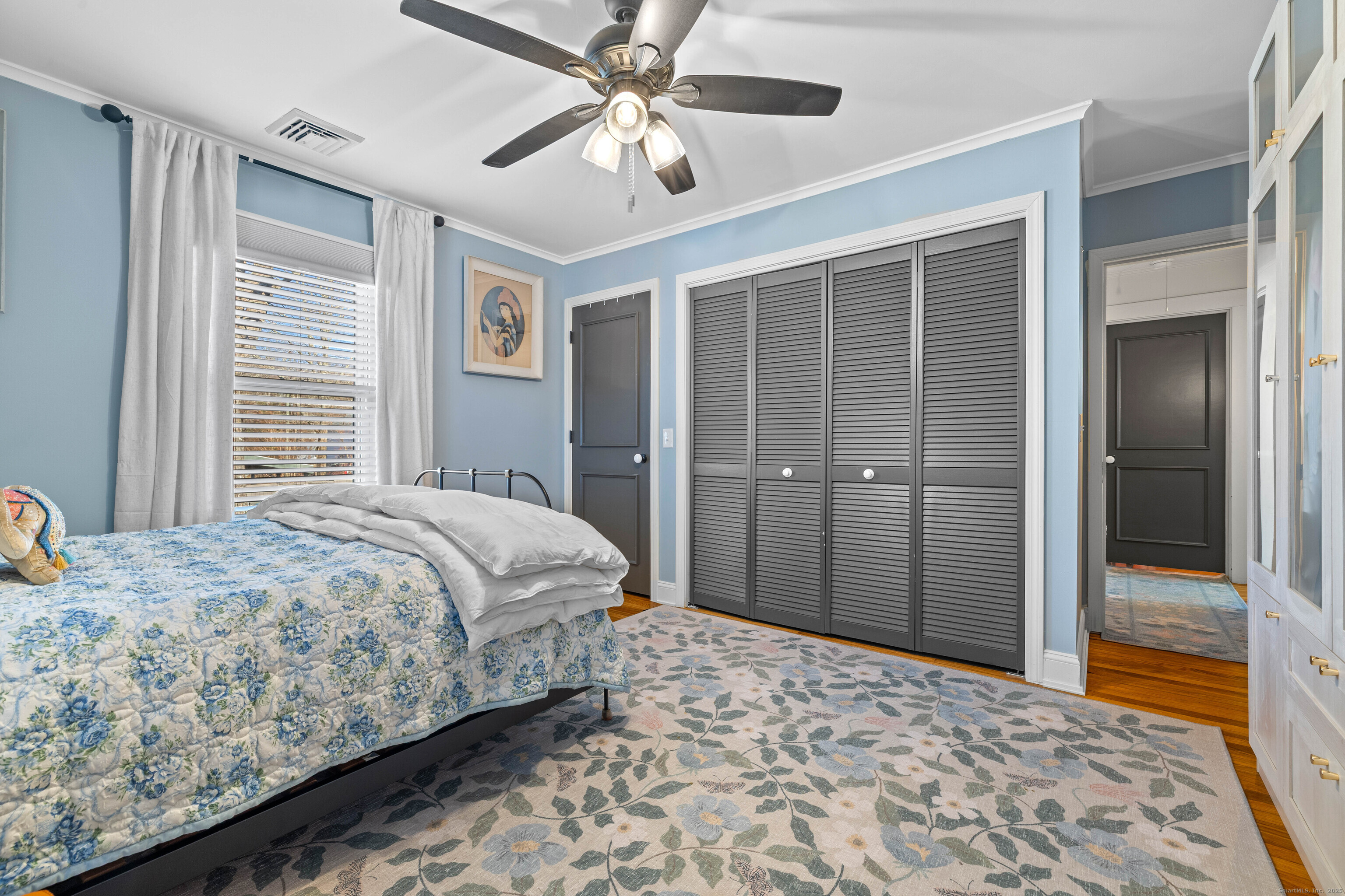 552 Laurel Hill Road Norwich, CT 06360 - Photo 26 of 40 a bedroom with a large bed and a chandelier