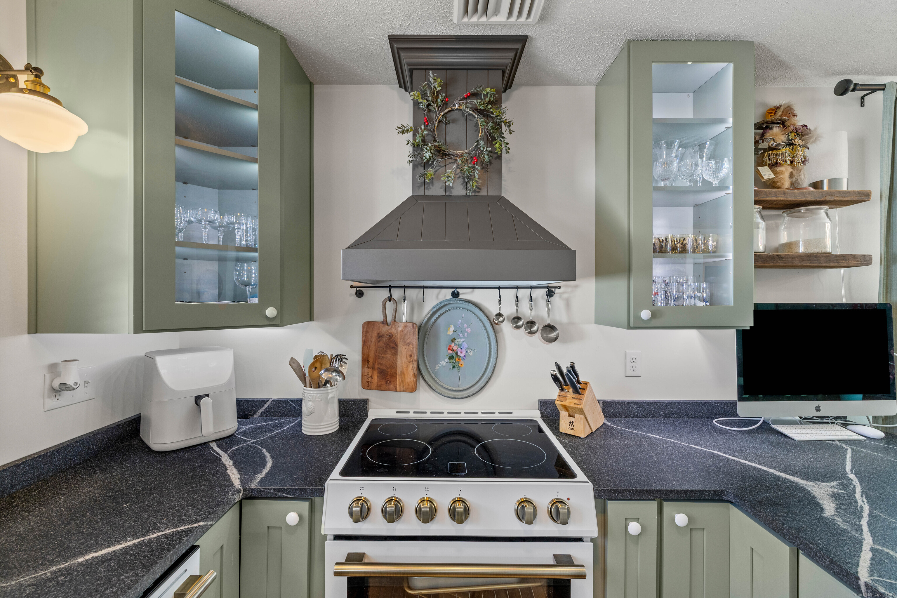 552 Laurel Hill Road Norwich, CT 06360 - Photo 3 of 40 a kitchen with a stove and a microwave