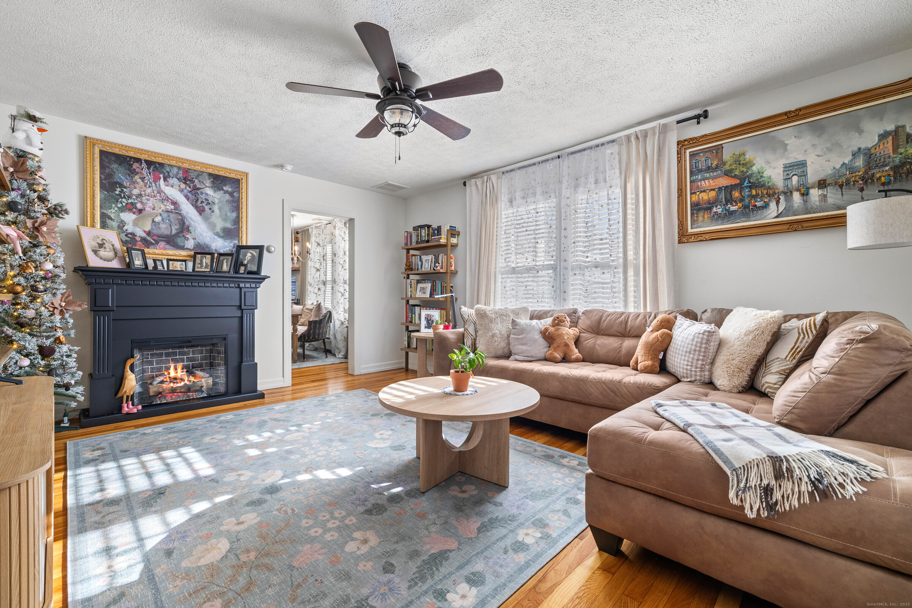 552 Laurel Hill Road Norwich, CT 06360 - Photo 7 of 40 a living room with furniture a fireplace and a flat screen tv