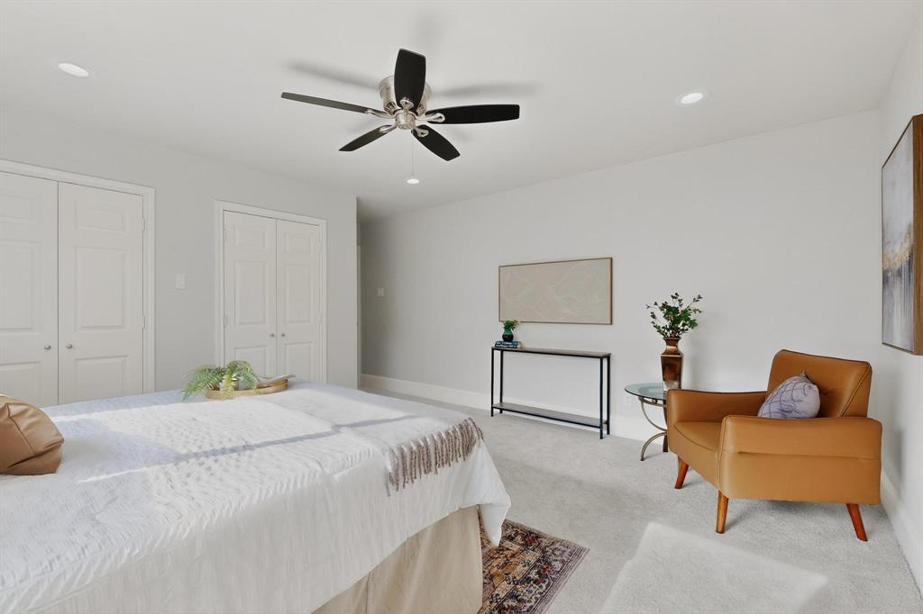 7625 Querida Lane Dallas, TX 75248 - Photo 14 of 32 a bedroom with a bed and a couch