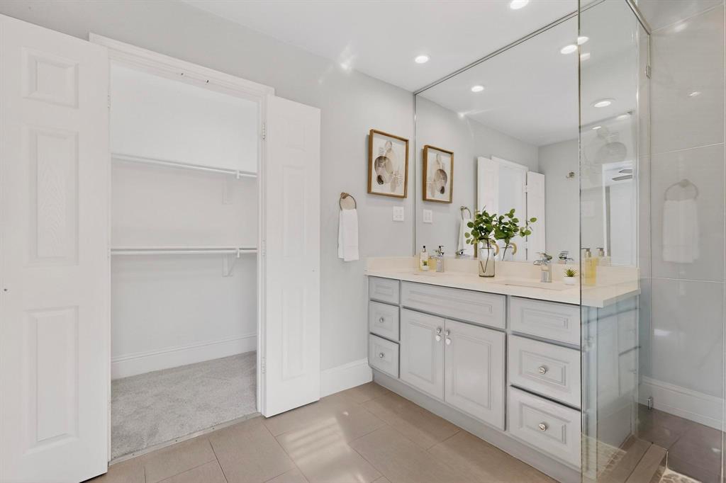 7625 Querida Lane Dallas, TX 75248 - Photo 16 of 32 a spacious bathroom with a double vanity sink and a mirror