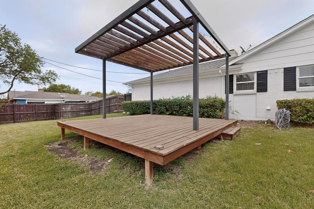 7625 Querida Lane Dallas, TX 75248 - Photo 27 of 32 a view of a wooden deck with a table and chairs