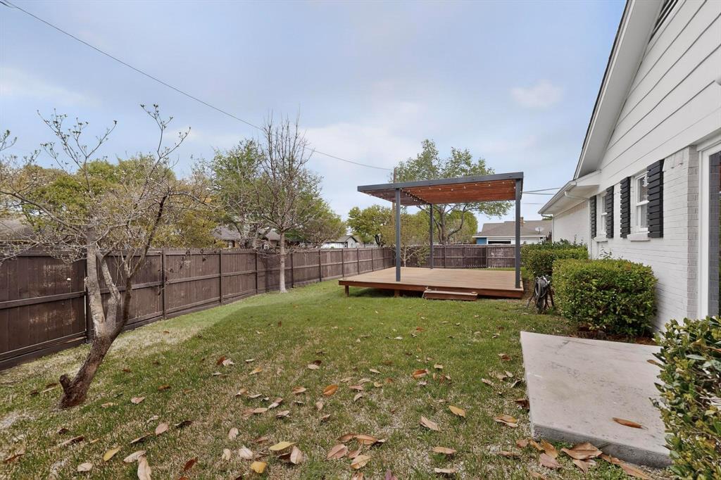 7625 Querida Lane Dallas, TX 75248 - Photo 28 of 32 a view of a backyard with plants and a patio
