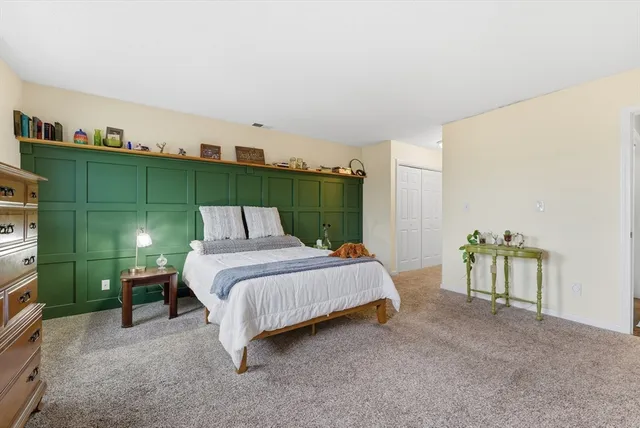 a bed sitting in a room next to a window