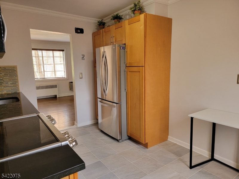 21C Troy Drive Springfield, NJ 07081 - Photo 12 of 17 a view of a refrigerator in kitchen and a window