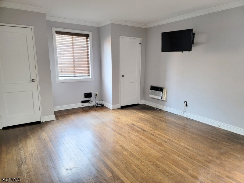 21C Troy Drive Springfield, NJ 07081 - Photo 14 of 17 an empty room with wooden floor and windows