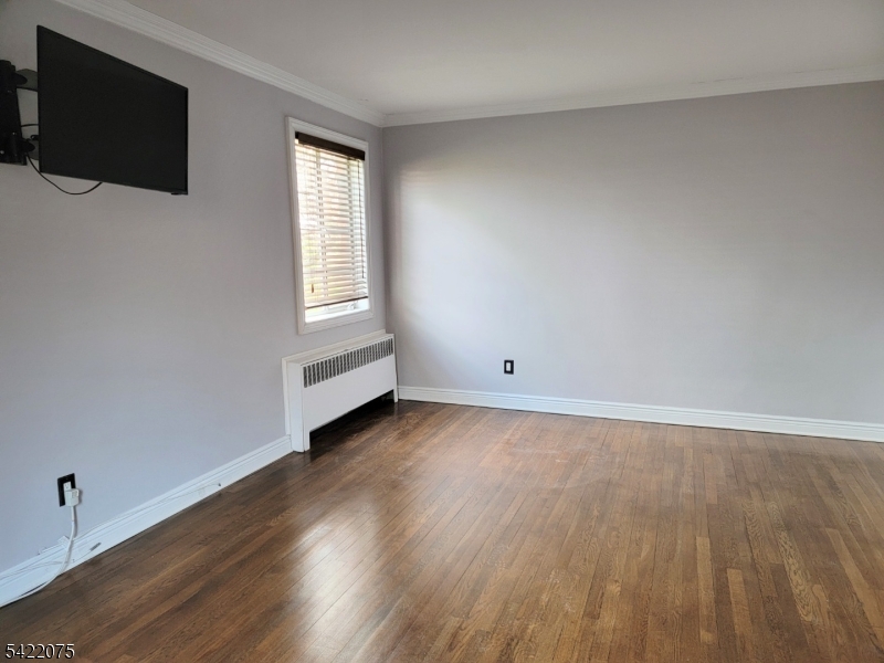 21C Troy Drive Springfield, NJ 07081 - Photo 15 of 17 wooden floor in an empty room with a window