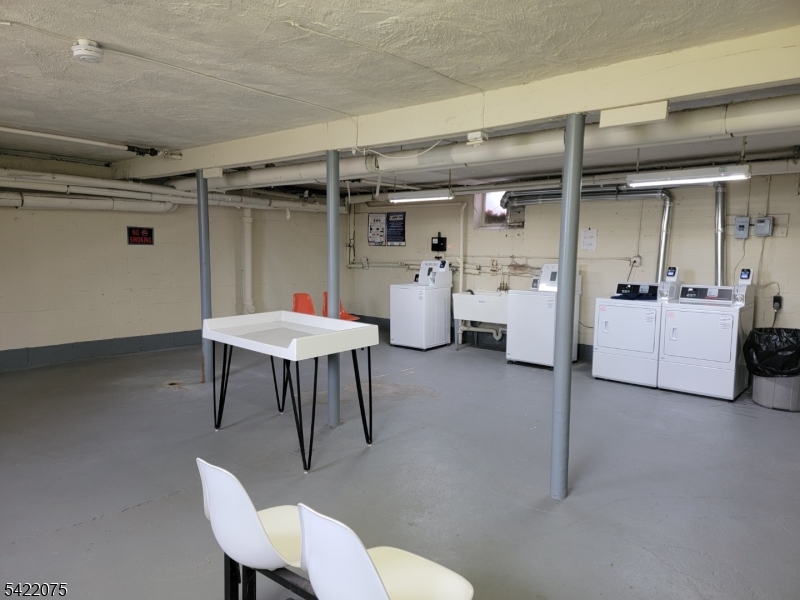 21C Troy Drive Springfield, NJ 07081 - Photo 17 of 17 a living room with furniture and a table