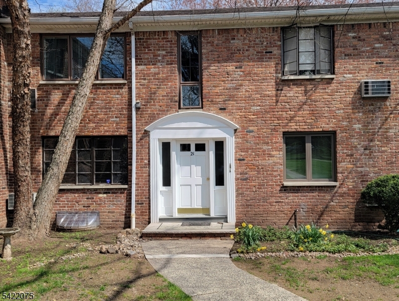 21C Troy Drive Springfield, NJ 07081 - Photo 2 of 17 a front view of a house with a garden