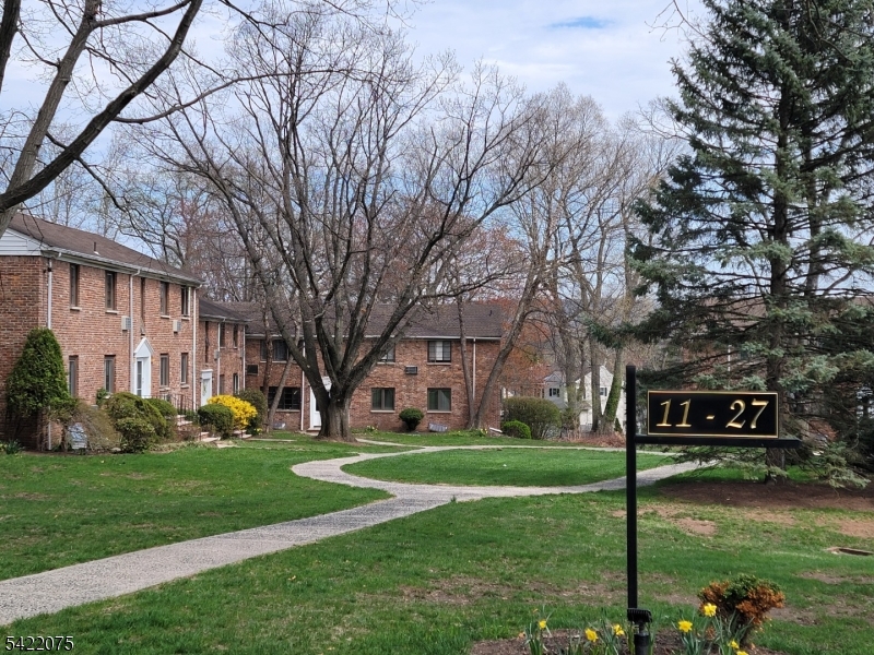 21C Troy Drive Springfield, NJ 07081 - Photo 4 of 17 a front view of a building with garden