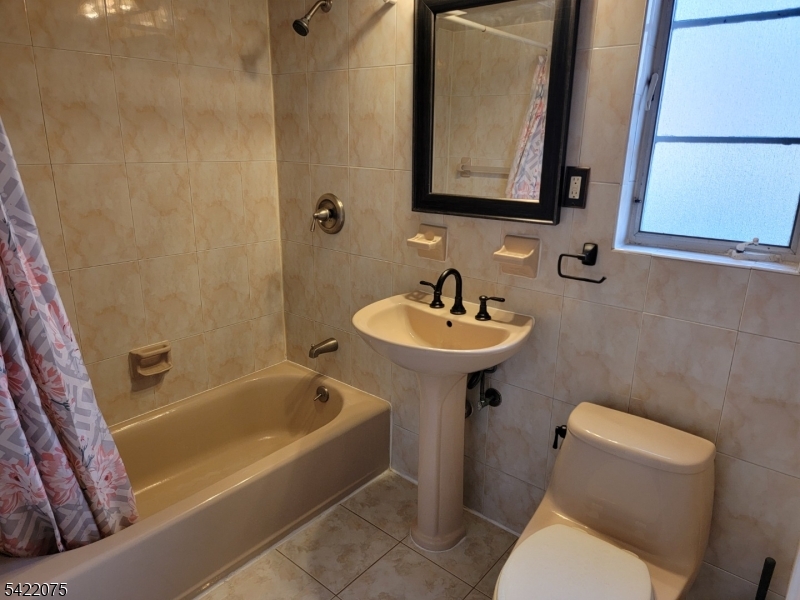 21C Troy Drive Springfield, NJ 07081 - Photo 10 of 17 a bathroom with a sink a toilet and bathtub