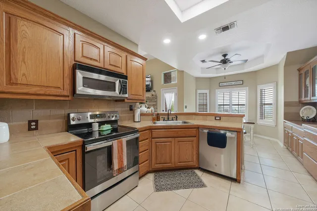 a kitchen with stainless steel appliances granite countertop a sink and cabinets