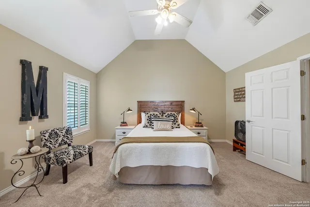 a bedroom with bed and a chandelier