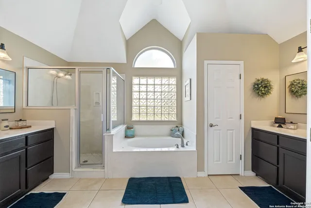 a bathroom with a tub a sink and a mirror
