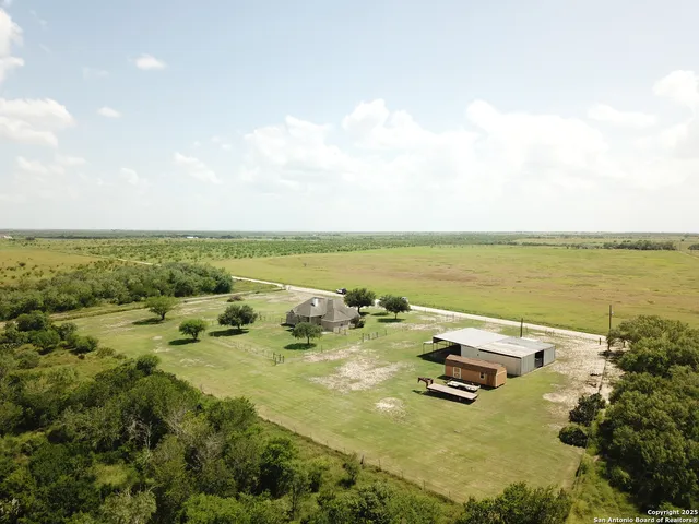 an aerial view of a houses with ocean view